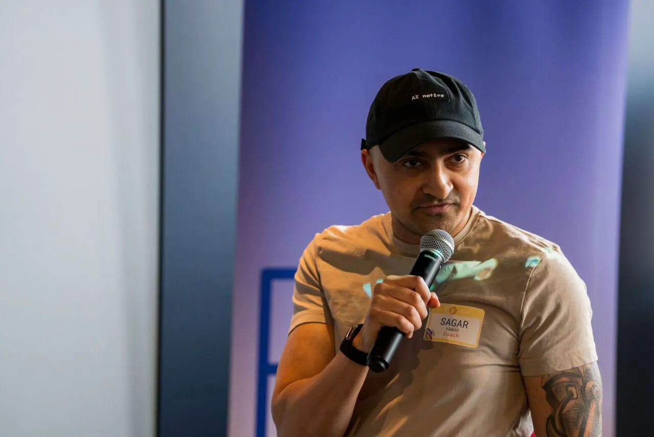 Sagar Pandya speaking with a microphone at an event